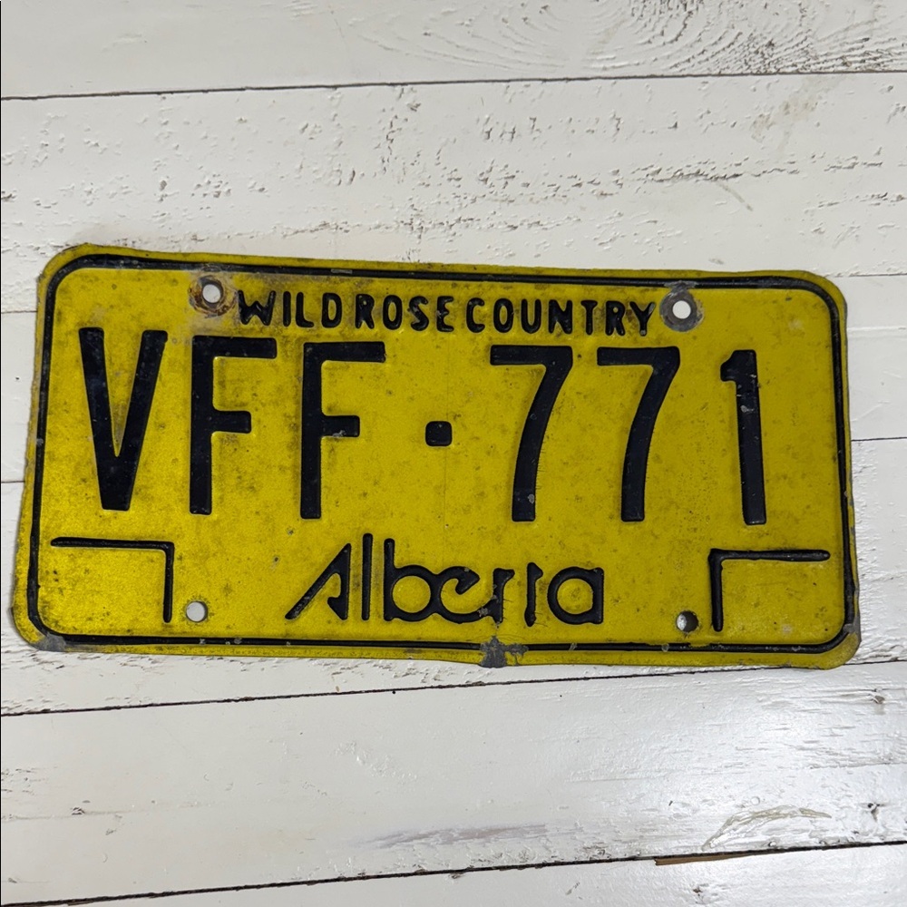 This is a vintage Alberta license plate from the "Wild Rose Country 1975 b1984.